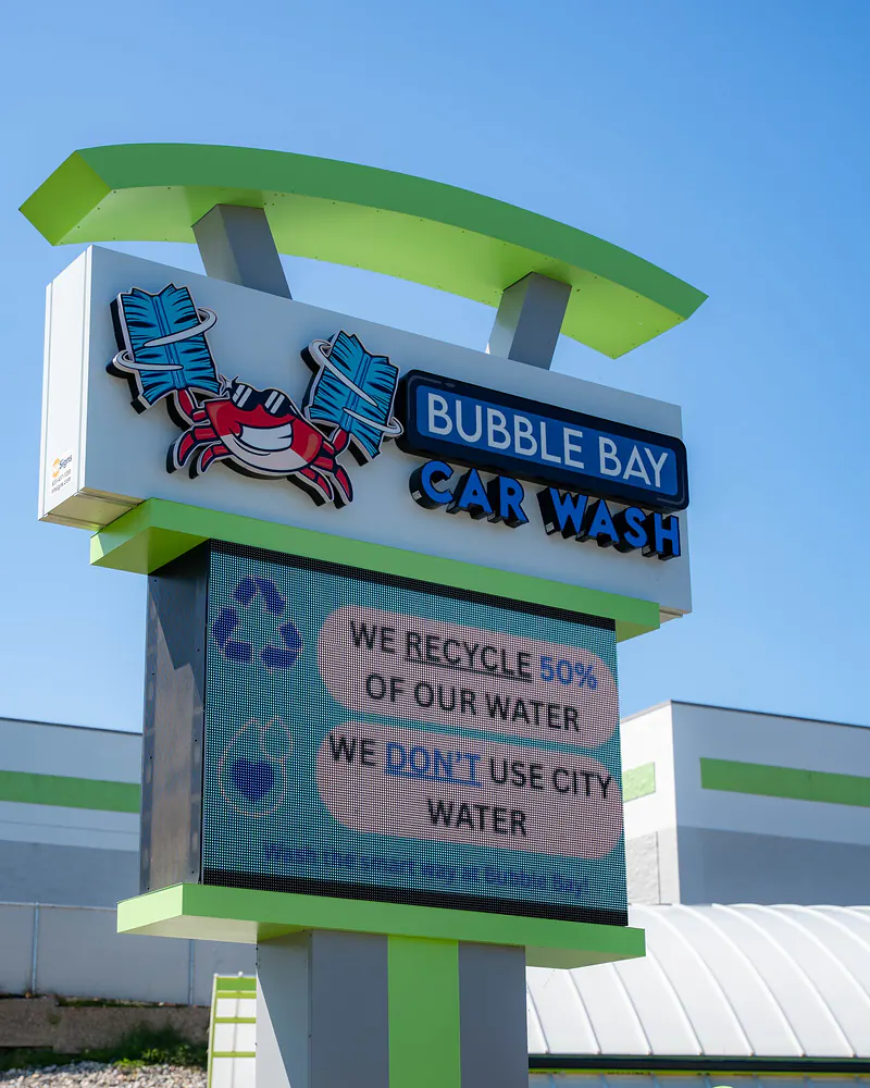 The Bubble Bay Car Wash roadside sign, with a message board about recycling water